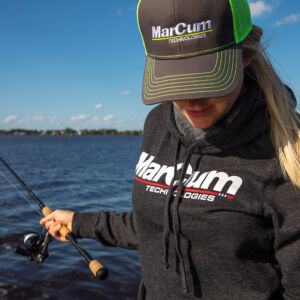 Morgan wearing performance hoodie and green ball cap by open water