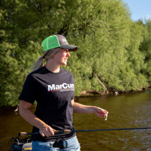 Morgan wearing MarCum t-shirt and green ball cap by open water