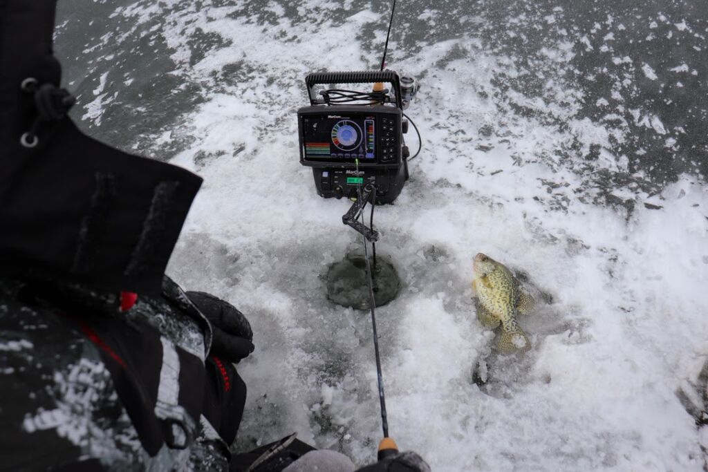 Premium Photo  Winter fishing fishing rod with a fishing line near the ice  hole ice with snow